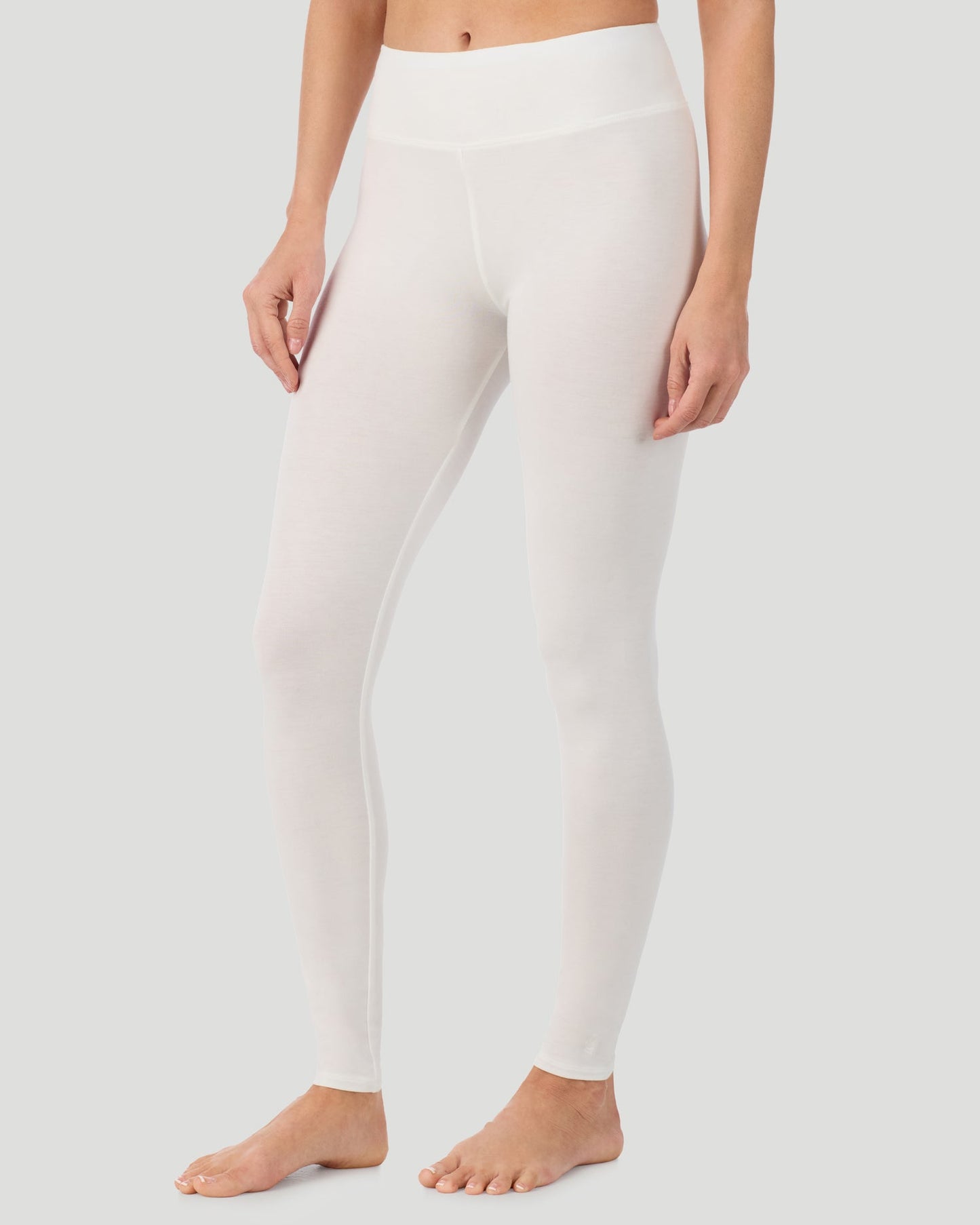 Ivory; Model is wearing a size S. She is 5’11.5”, Bust 34”, Waist 27”, Hips 38.5”.  @A lady wearing Softwear With Stretch High Waist Legging in ivory in a front view side angle pose