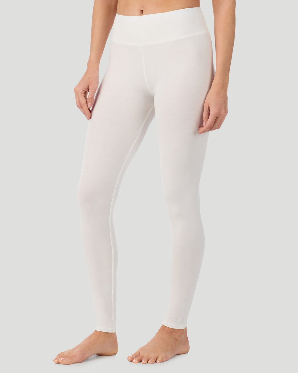 A lady wearing Softwear With Stretch High Waist Legging in ivory in a front view side angle pose