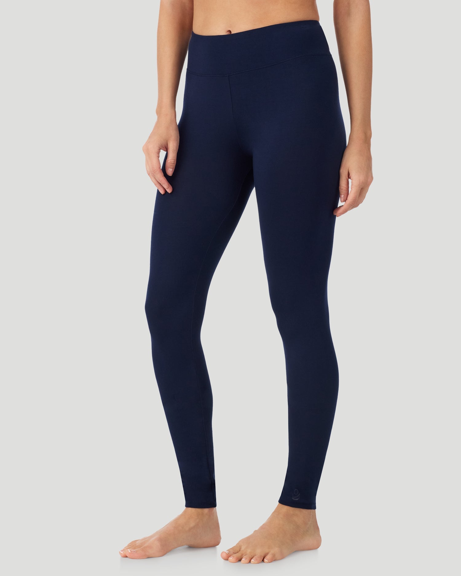 A lady wearing Softwear With Stretch High Waist Legging in navy blazer in a front view side angle pose  