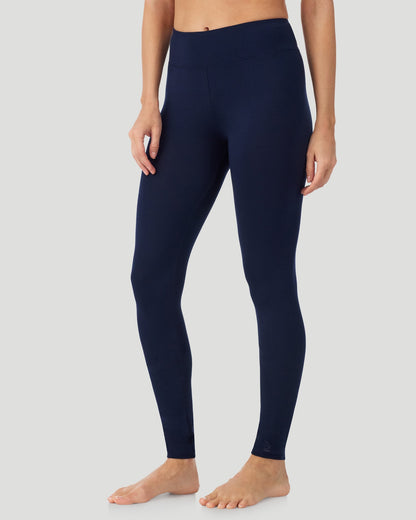 A lady wearing Softwear With Stretch High Waist Legging in navy blazer in a front view side angle pose  