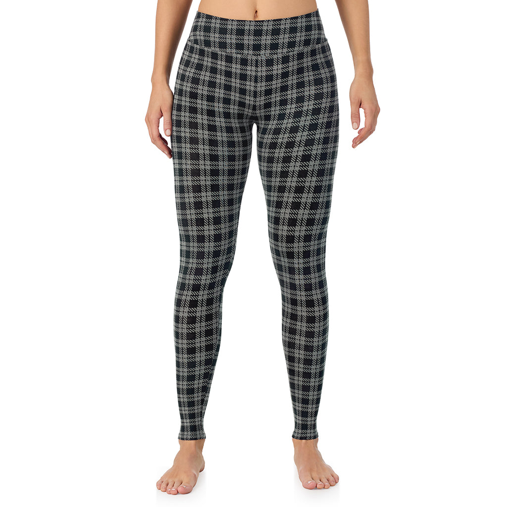 A lady wearing a charcoal/black plaid high waist legging.