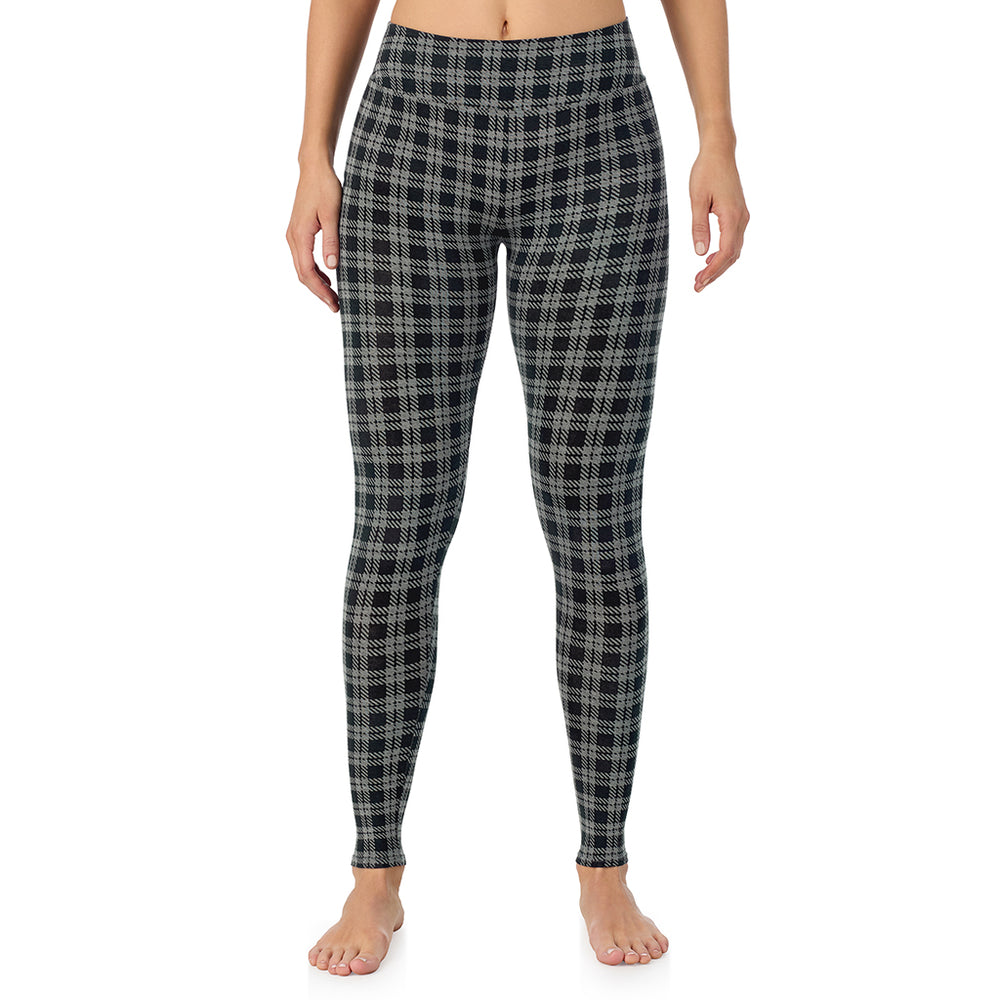 A lady wearing a charcoal/black plaid high waist legging.