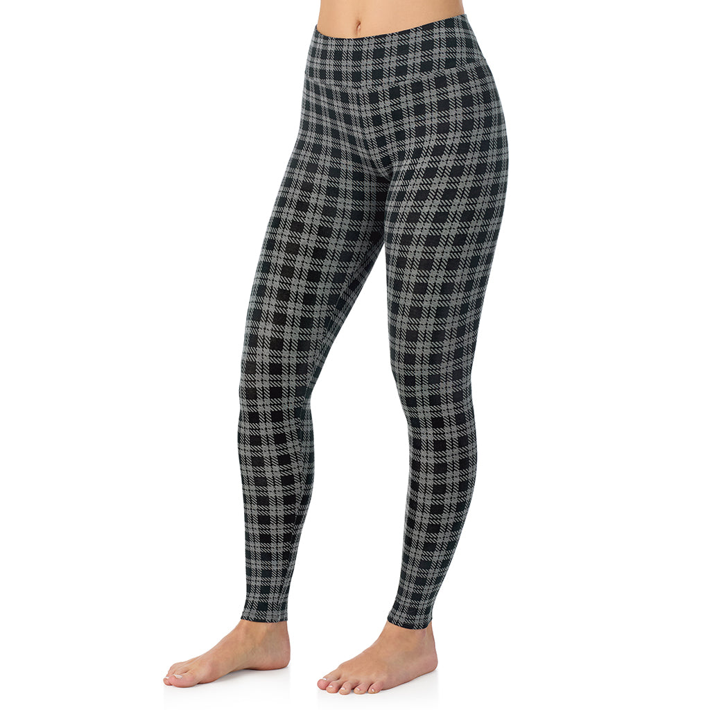 A lady wearing a charcoal/black plaid high waist legging.