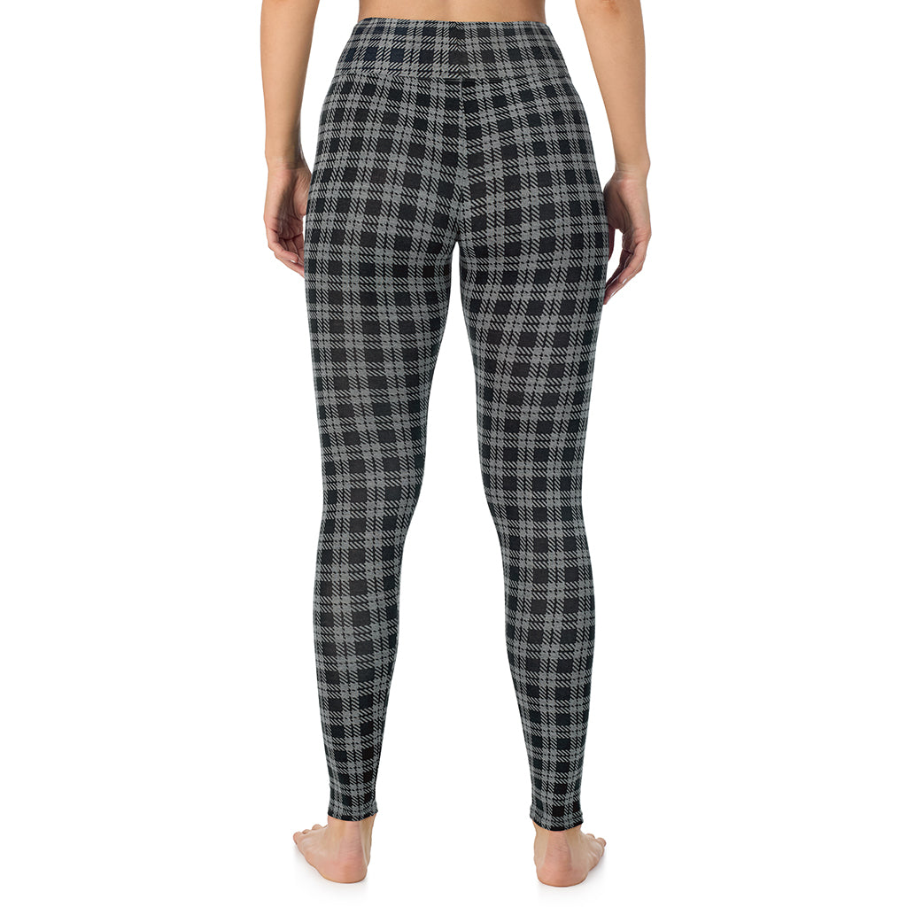 A lady wearing a charcoal/black plaid high waist legging.