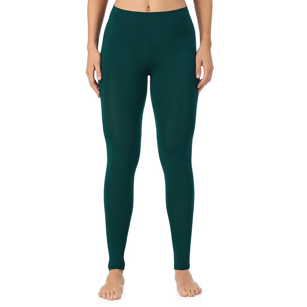 A lady wearing a dark pine high waist legging.