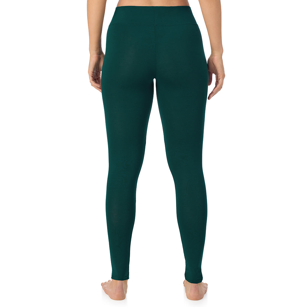 A lady wearing a dark pine high waist legging.