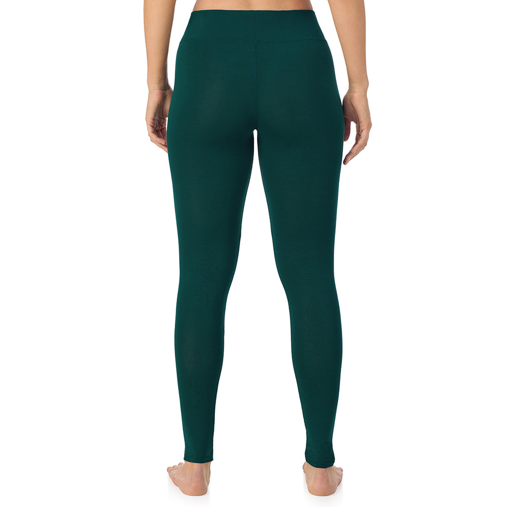 A lady wearing a dark pine high waist legging.