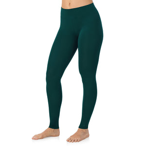 A lady wearing a dark pine high waist legging.