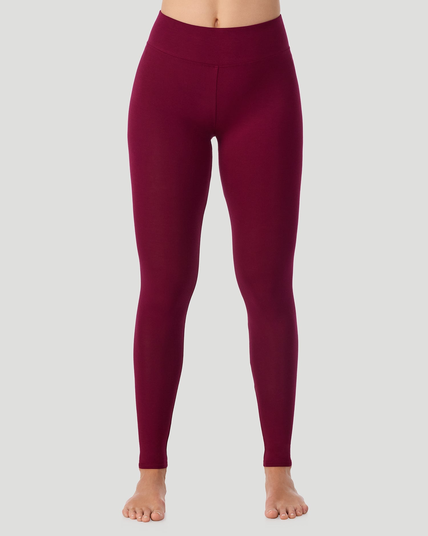 A lady wearing Softwear With Stretch High Waist Legging in scarlet posing in a front view position