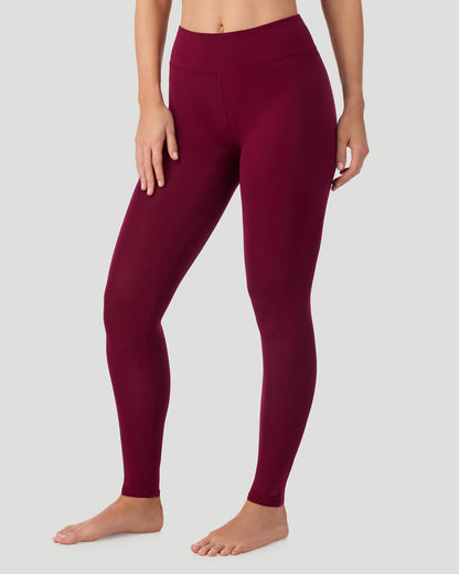 A lady wearing Softwear With Stretch High Waist Legging in scarlet in a front view side angle pose
