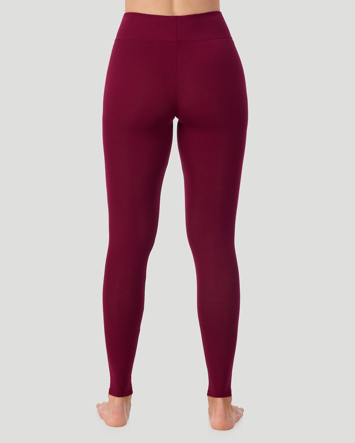 A lady wearing Softwear With Stretch High Waist Legging in scarlet in a back view pose