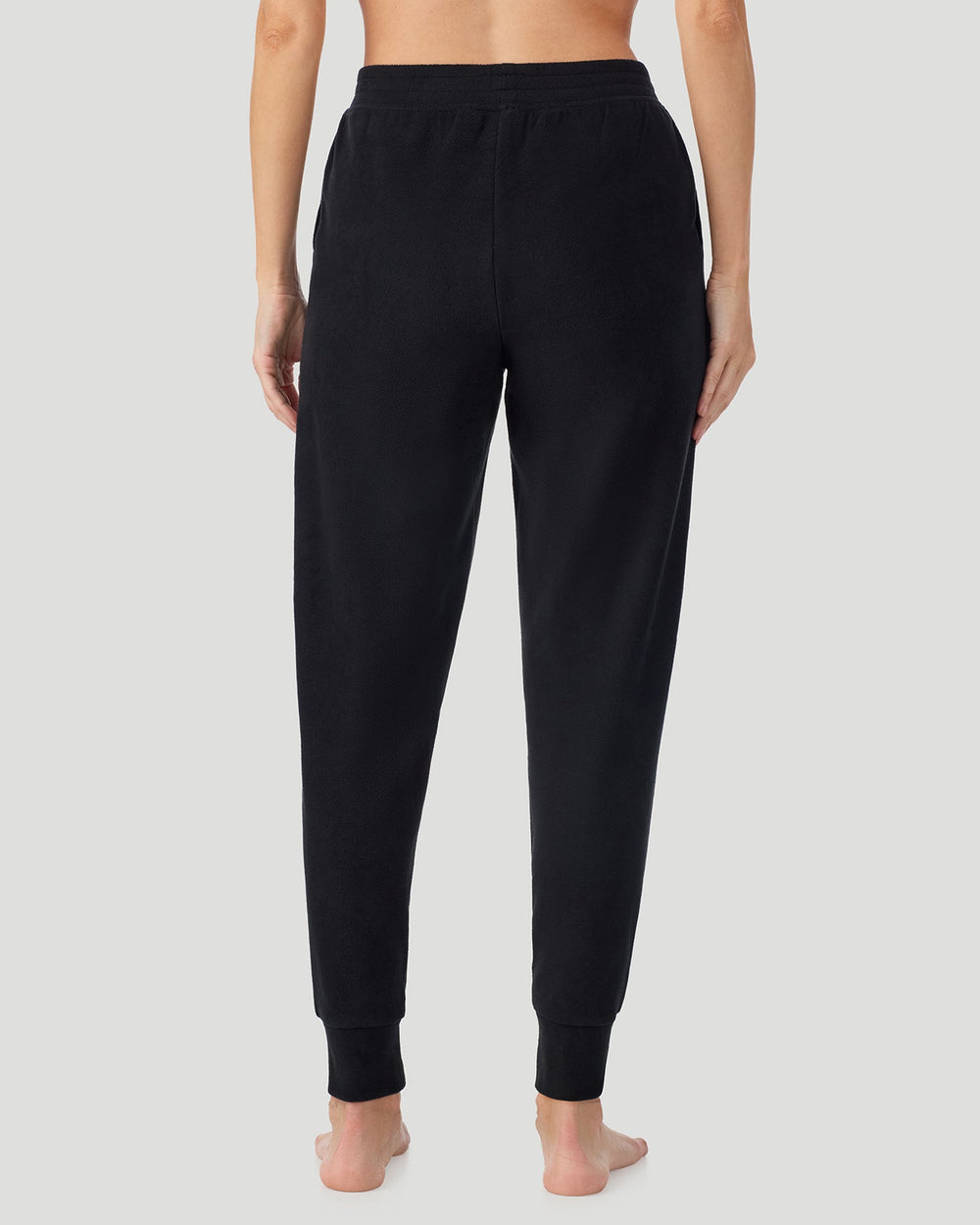 A lady wearing Black Fleecewear With Stretch Jogger in a back view pose