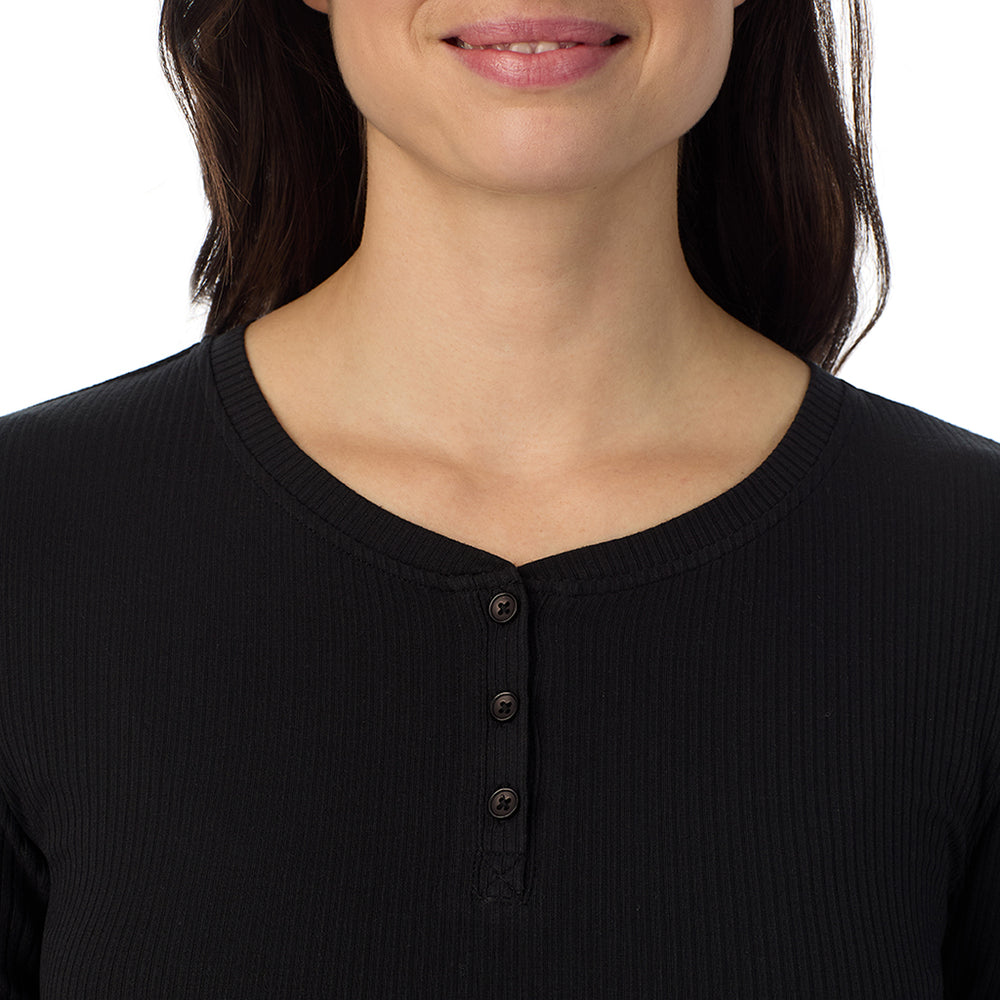 A lady is wearing a Black Stretch Rib Long Sleeve Henley
