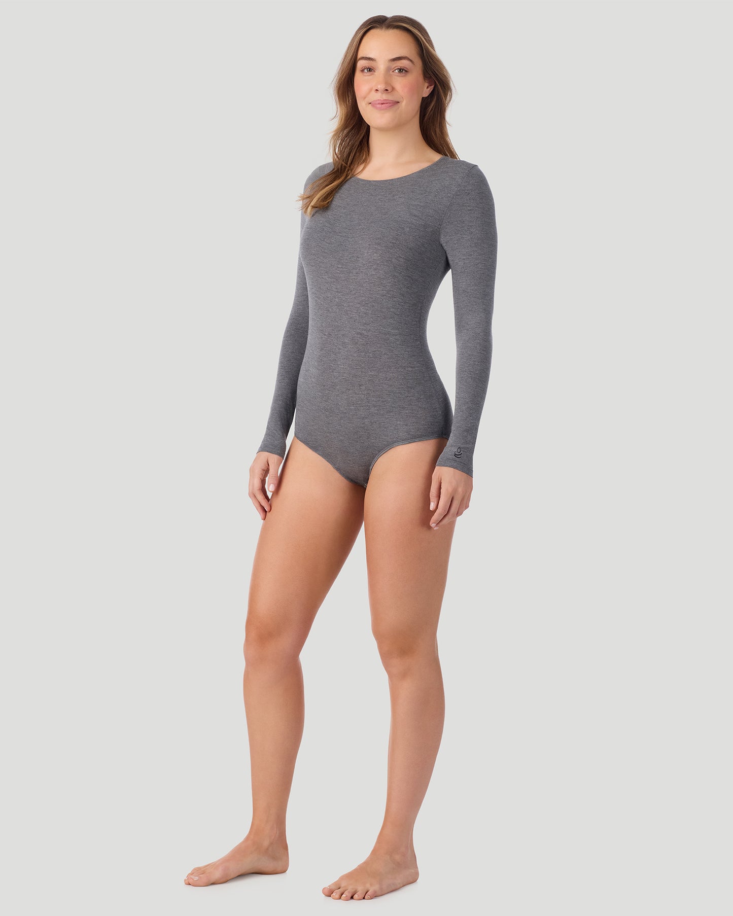 Charcoal Heather; Model is wearing size S. She is 5’9”, Bust 32”, Waist 25.5”, Hips 36”. @A lady wearing Softwear With Stretch Long Sleeve Bodysuit in charcoal heather shown in a front view standing pose
