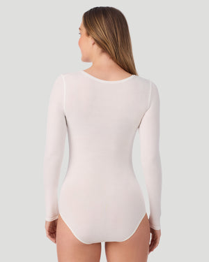 A lady wearing Softwear With Stretch Long Sleeve Bodysuit in ivory shown in a back view pose