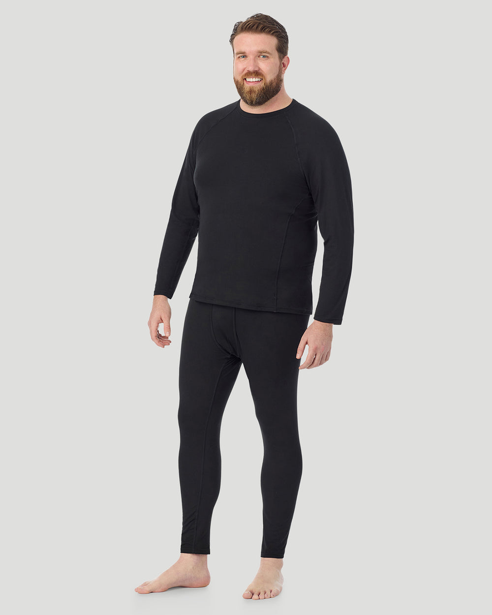 A man wearing black long sleeve crew t-shirt side pose