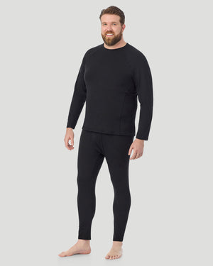 A man wearing black long sleeve crew t-shirt side pose