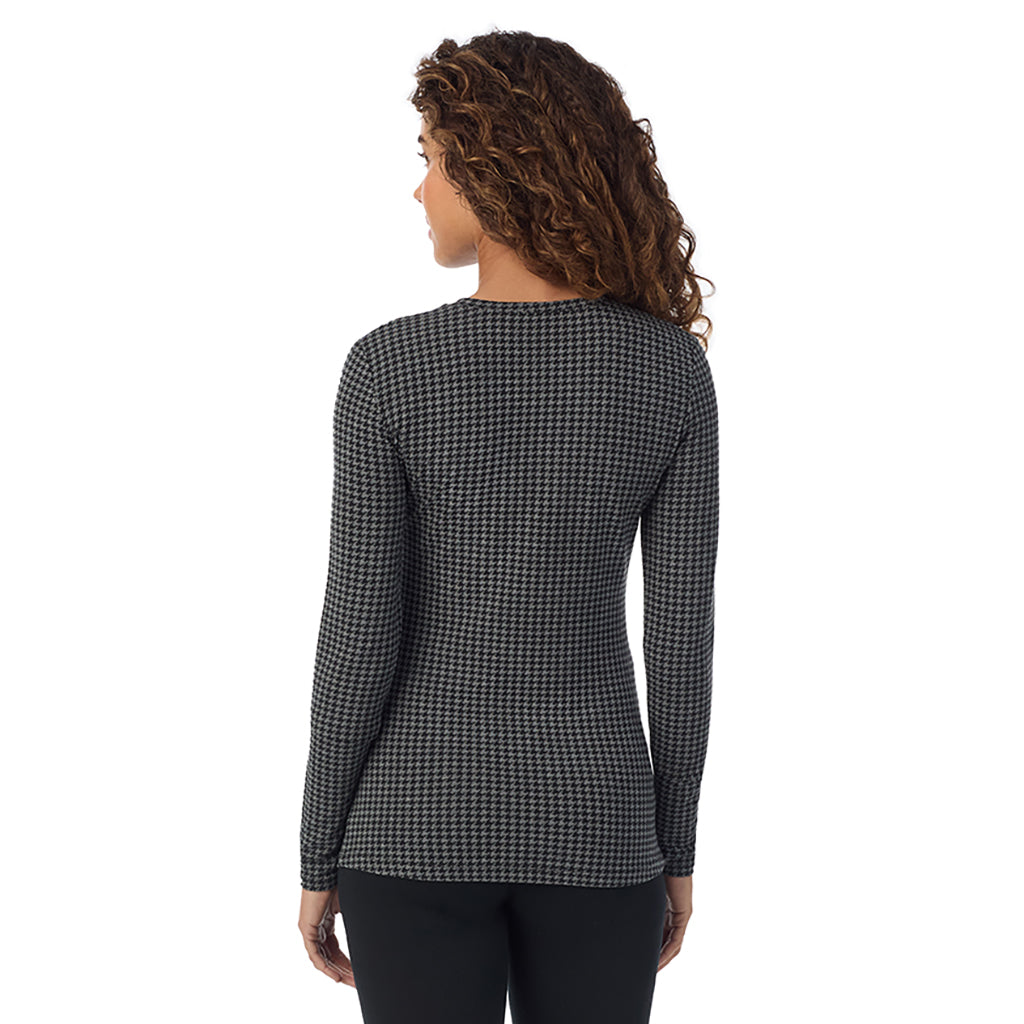 A lady wearing charcoal heather houndsooth long sleeve crew petite softwear with stretch top.