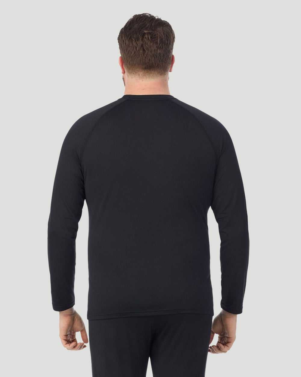 A man wearing Black ArctiCore Long Sleeve Crew Big & Tall in a back view pose