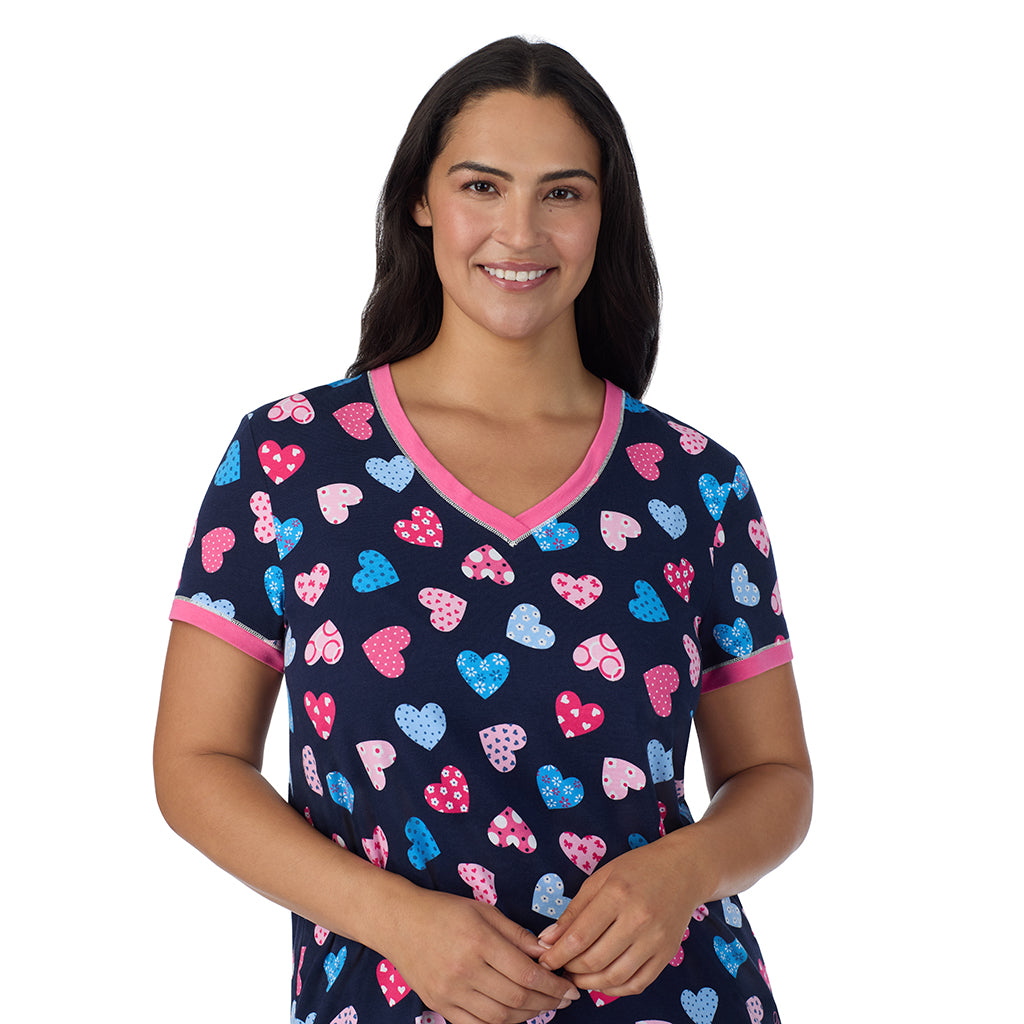 A lady wearing Navy Multi Hearts Cotton-Blend Short Sleeve Top with Cropped Pant 2-Pc Pajama Set PLUS 