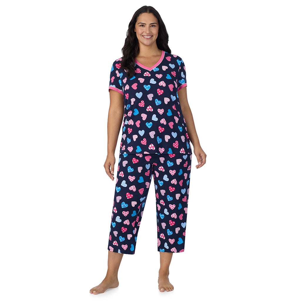 A lady wearing Navy Multi Hearts Cotton-Blend Short Sleeve Top with Cropped Pant 2-Pc Pajama Set PLUS 