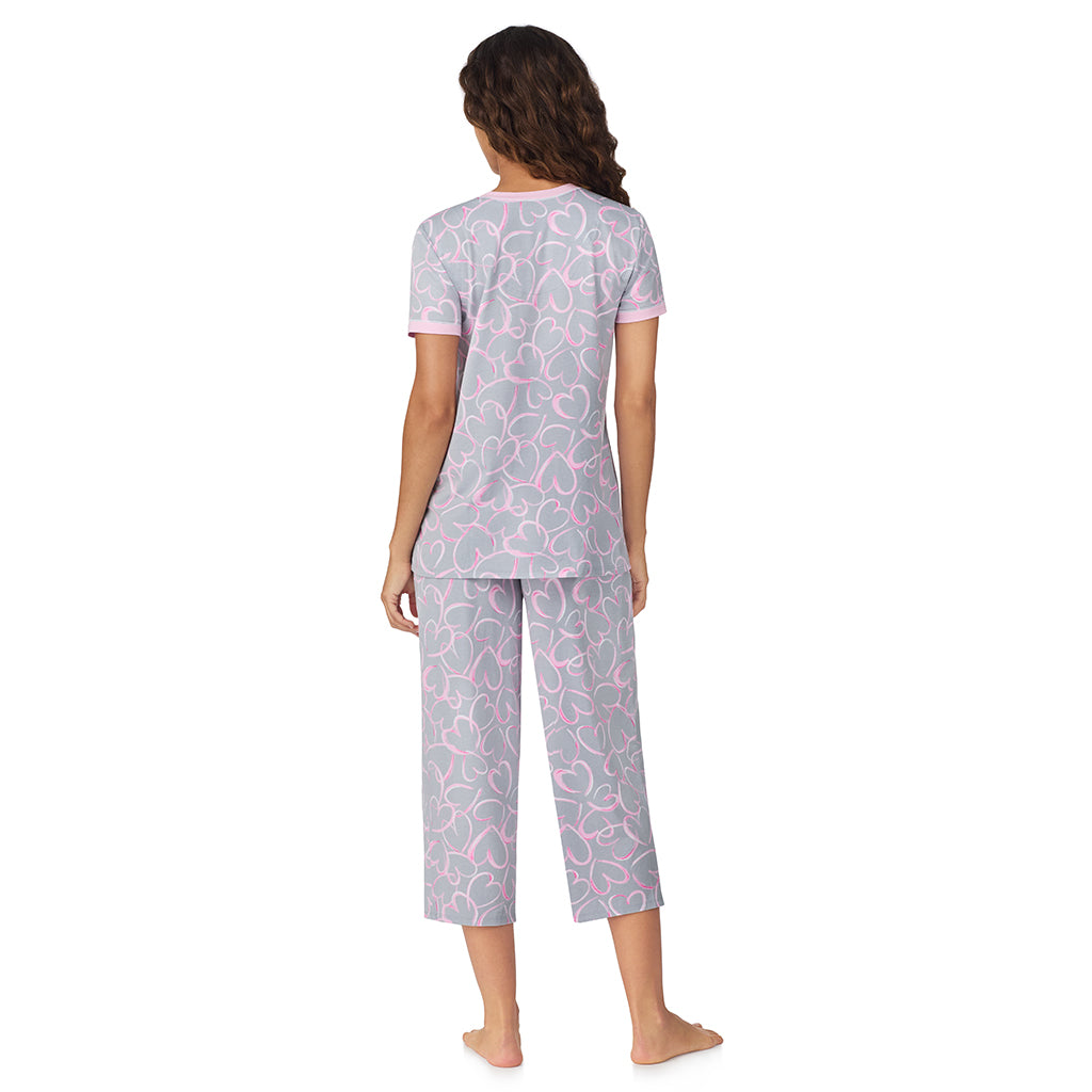 A lady wearing Grey Scribble Hearts Cotton-Blend Short Sleeve Top with Cropped Pant 2-Pc Pajama Set 