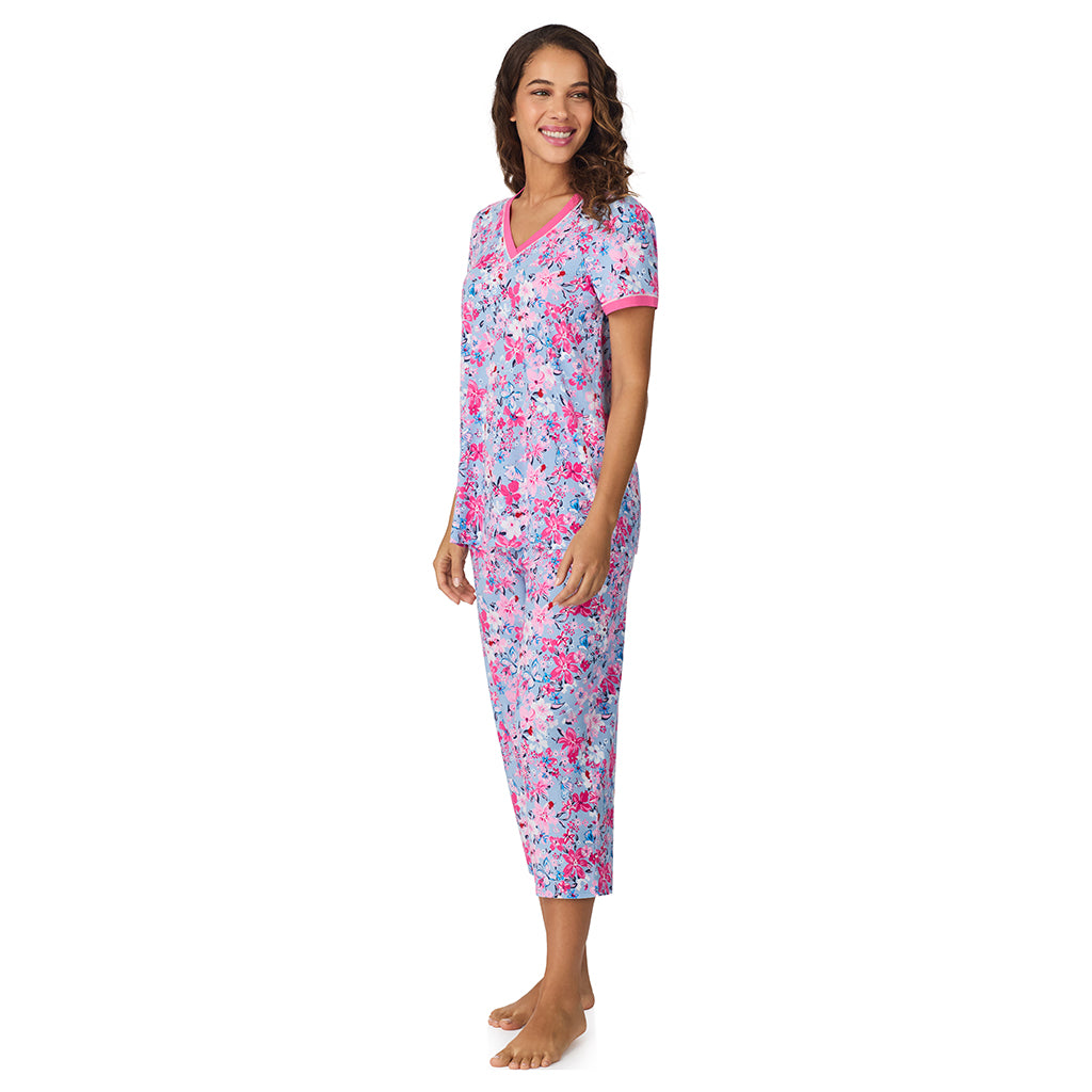 A lady wearing Blue Multi Floral Cotton-Blend Short Sleeve Top with Cropped Pant 2-Pc Pajama Set 