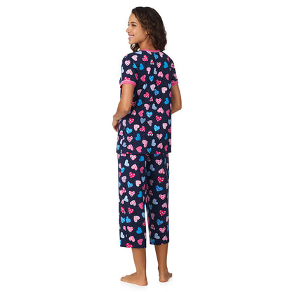 Navy Multi Hearts;Model is wearing size S. She is 5’9”, Bust 34”, Waist 23”, Hips 35”.@A lady wearing Navy Multi Hearts Cotton-Blend Short Sleeve Top with Cropped Pant 2-Pc Pajama Set !57% Cotton, 38% Modal, 5% Spandex!