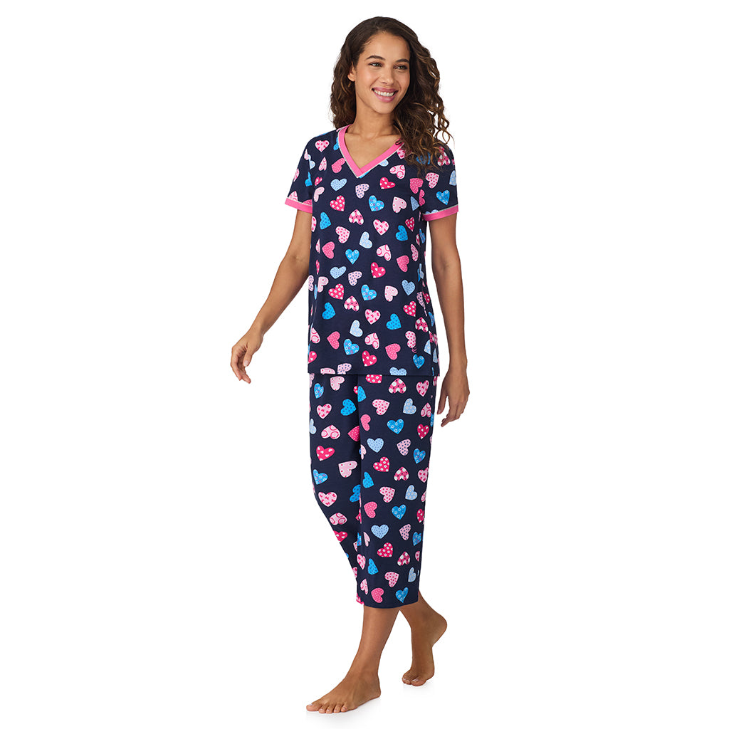 A lady wearing Navy Multi Hearts Cotton-Blend Short Sleeve Top with Cropped Pant 2-Pc Pajama Set 