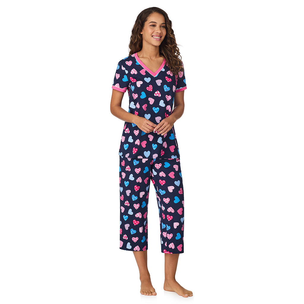 Navy Multi Hearts;Model is wearing size S. She is 5’9”, Bust 34”, Waist 23”, Hips 35”.@A lady wearing Navy Multi Hearts Cotton-Blend Short Sleeve Top with Cropped Pant 2-Pc Pajama Set !57% Cotton, 38% Modal, 5% Spandex!