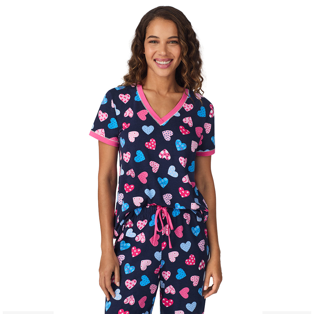 A lady wearing Navy Multi Hearts Cotton-Blend Short Sleeve Top with Cropped Pant 2-Pc Pajama Set 