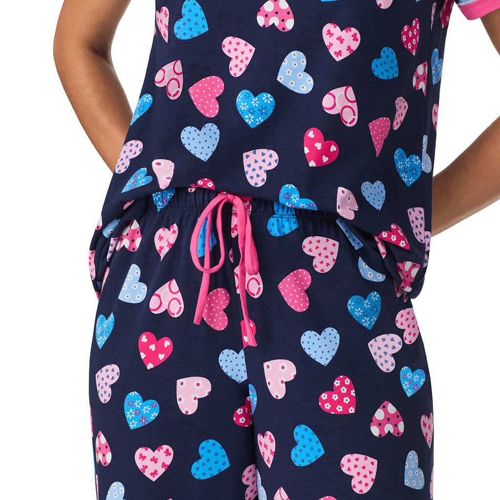 A lady wearing Navy Multi Hearts Cotton-Blend Short Sleeve Top with Cropped Pant 2-Pc Pajama Set 