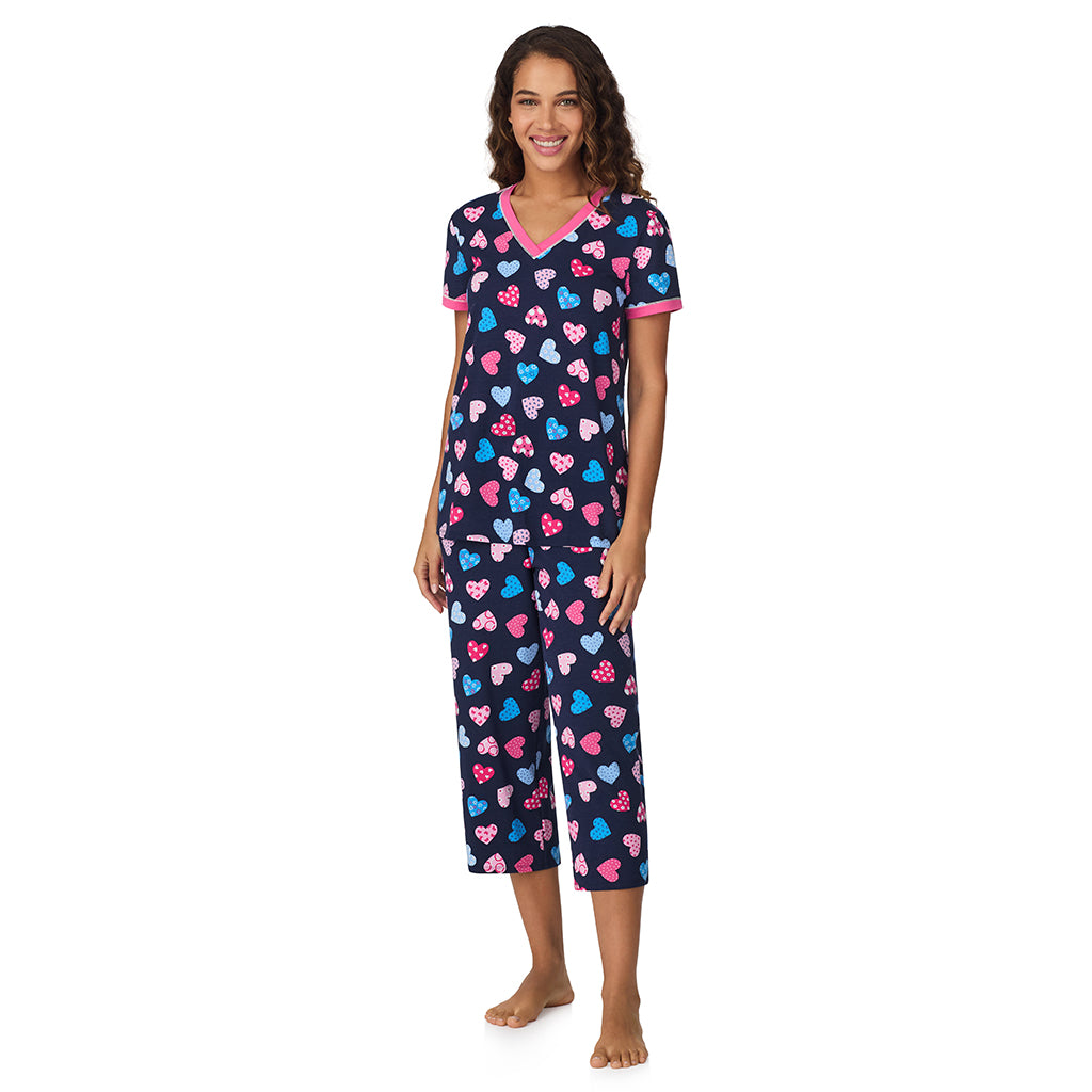 Navy Multi Hearts;Model is wearing size S. She is 5’9”, Bust 34”, Waist 23”, Hips 35”.@A lady wearing Navy Multi Hearts Cotton-Blend Short Sleeve Top with Cropped Pant 2-Pc Pajama Set !57% Cotton, 38% Modal, 5% Spandex!