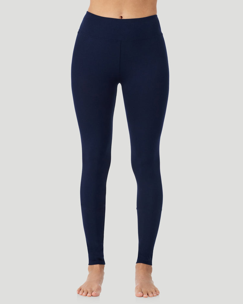 A lady wearing Softwear With Stretch High Waist Legging in navy blazer in a front view side angle pose