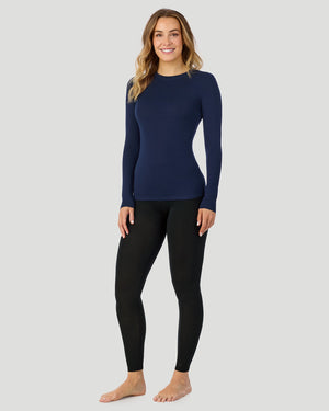 A plus size lady wearing Softwear With Stretch High Waist Legging PLUS in ivory in a back view pose