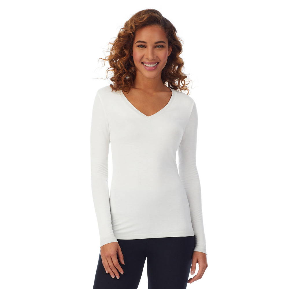 A lady wearing ivory long sleeve v-neck tall softwear with stretch top.
