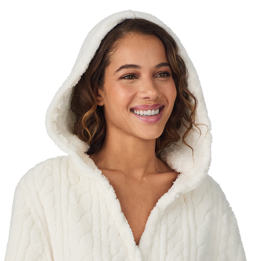 A lady wearing Ivory Cable Jacquard Sherpa Wrap Robe with Hood