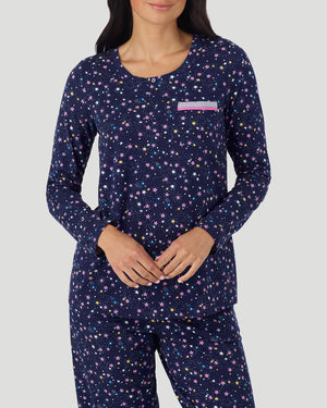A lady wearing Cotton-Blend Long Sleeve Top and Long Pant Pajama Set in Navy Star Print closer look hand together