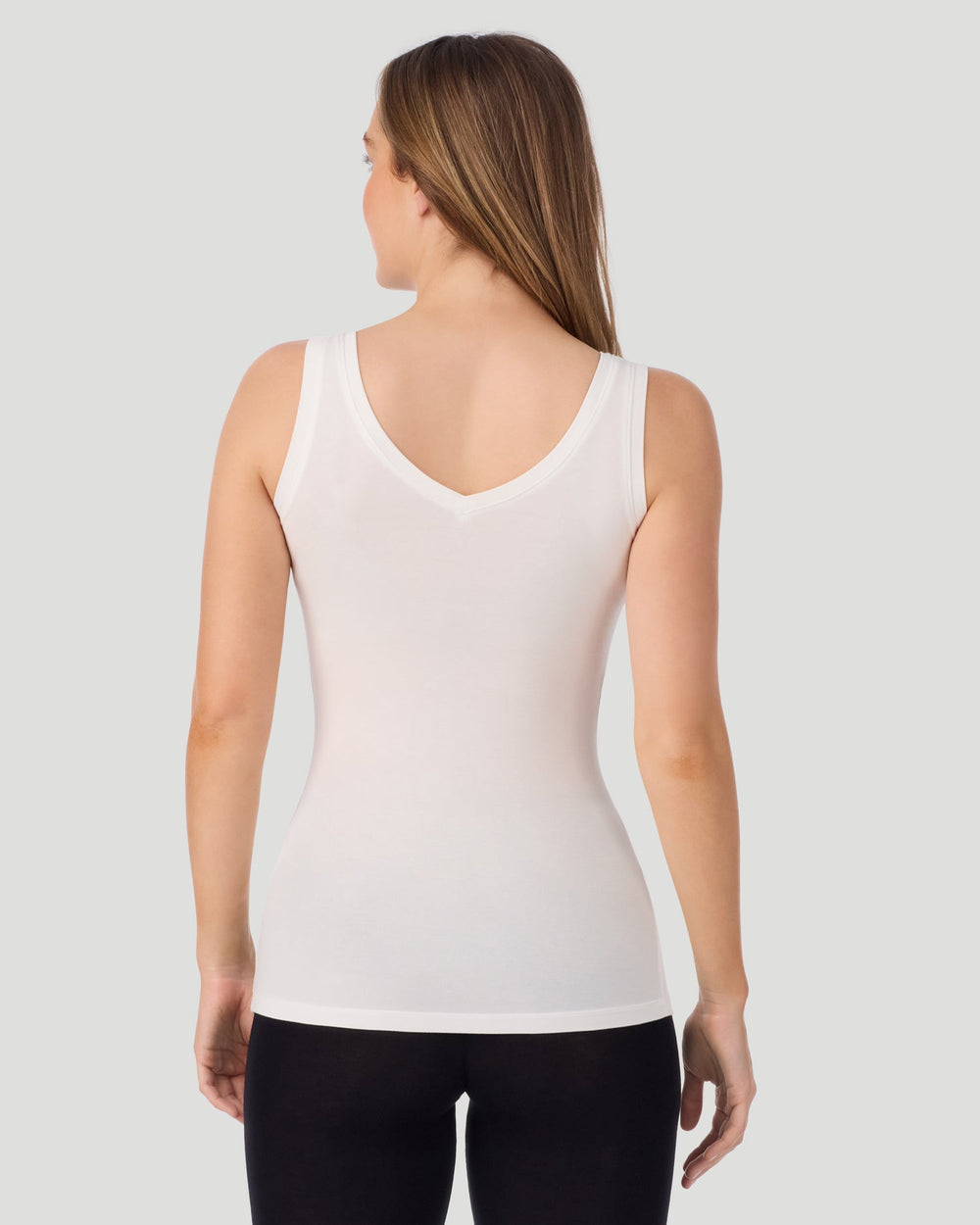 A lady wearing Softwear With Stretch Long Sleeve Bodysuit in ivory shown in a front view pose