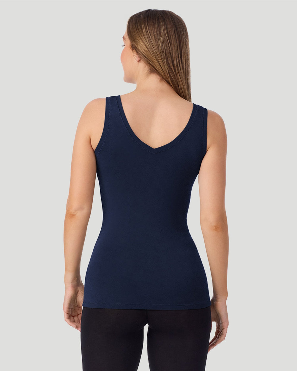 A lady wearing a black long sleeve stretch crew PETITE.