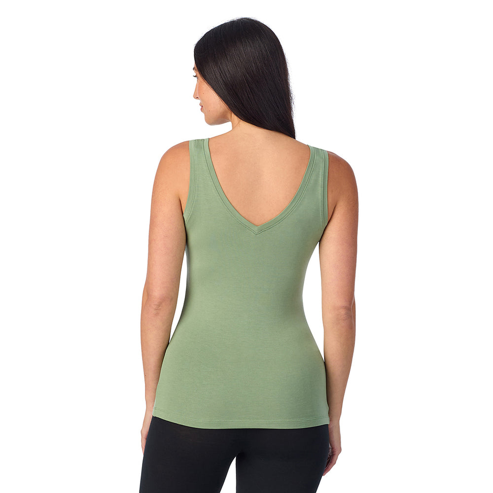 A lady wearing hedge green sleeveless reversible tank.