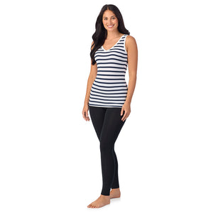 A lady wearing navy white stripe sleeveless reversible tank.