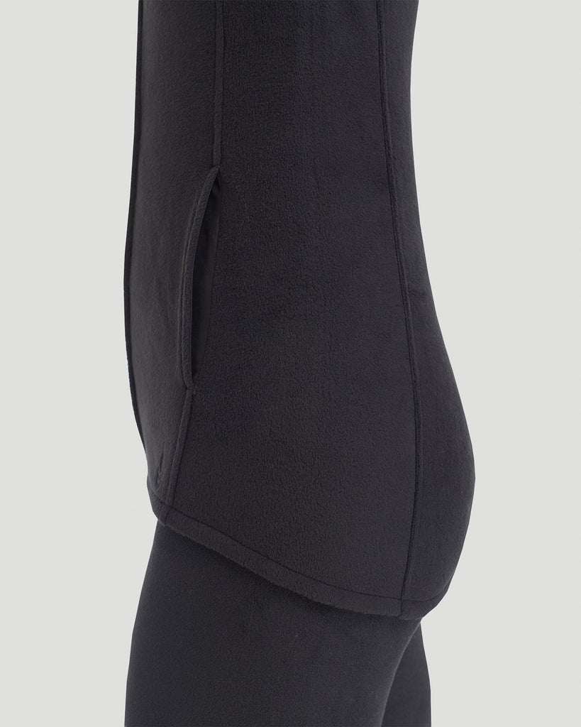 A lady wearing Fleecewear with Stretch Vest in Black back view back view
