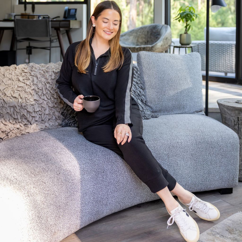 A lady wearing Black Cuddl Duds x Jennifer Lake Fleecewear with Stretch Half-Zip Pullover 