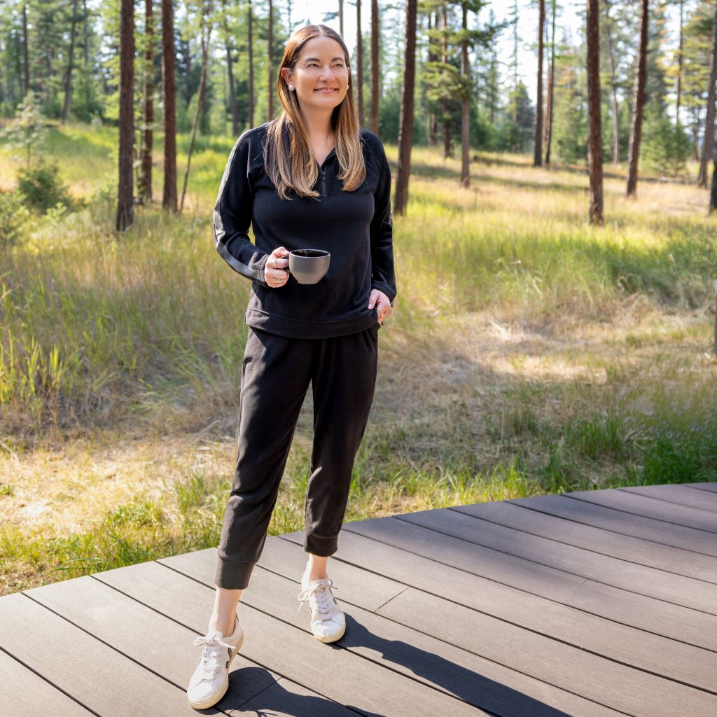 A lady wearing Black Cuddl Duds x Jennifer Lake Fleecewear with Stretch Half-Zip Pullover 