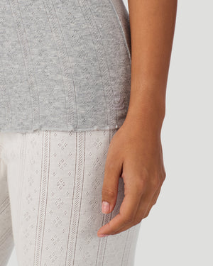  A lady wearing Grey Heather Cotton Pointelle Tank in a front view fabric detail close up view of the bottom hem