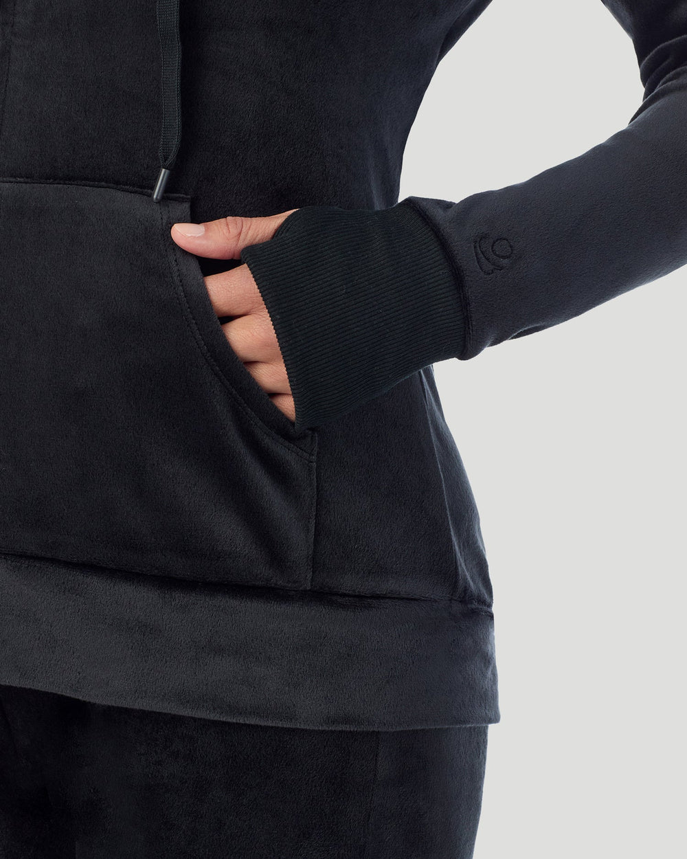 A lady wearing Stretch Velour Full Zip Hoodie in black shown in a front view detail close up shot