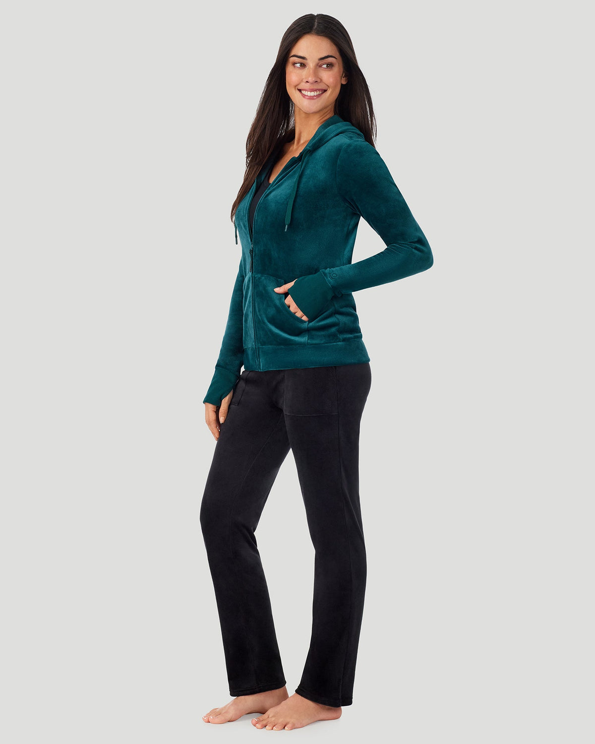 A lady wearing Stretch Velour Full Zip Hoodie in Deep Emerald