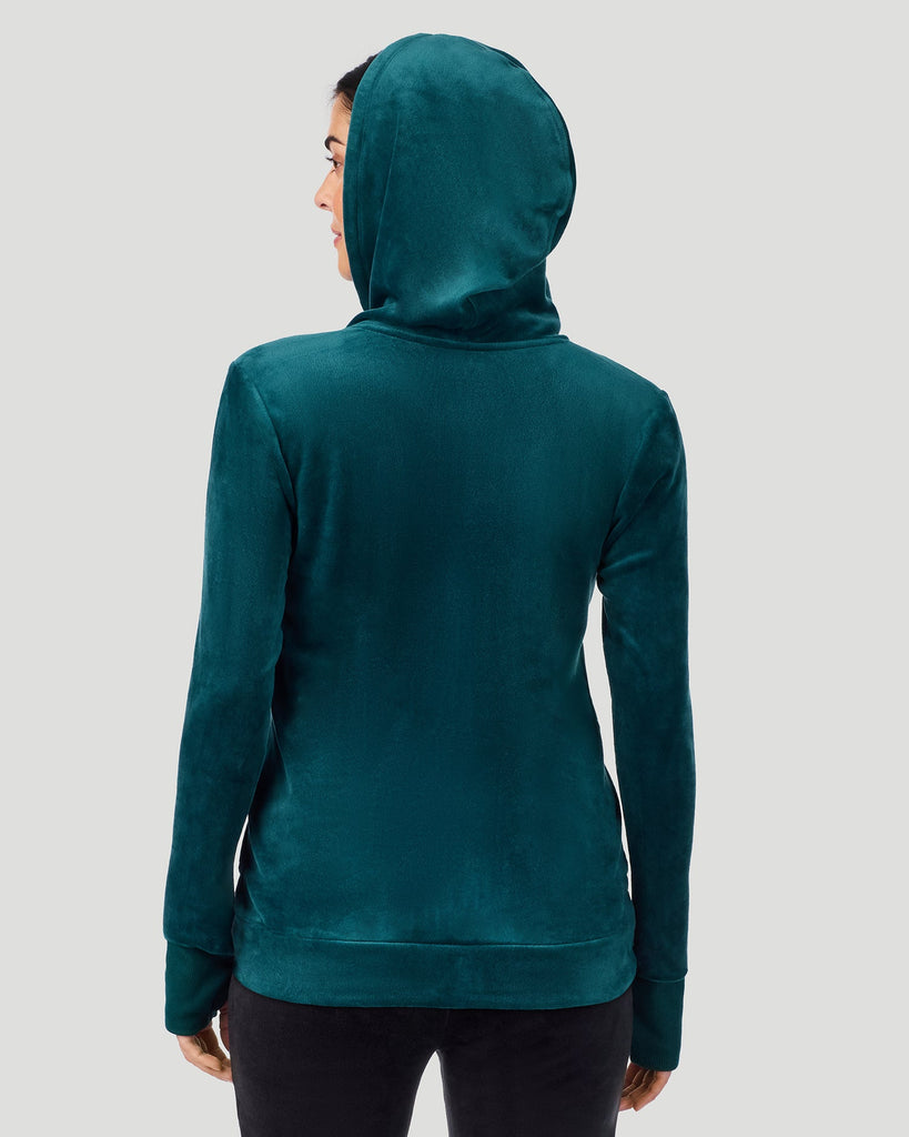 A lady wearing Stretch Velour Full Zip Hoodie in deep emerald shown in a back view pose