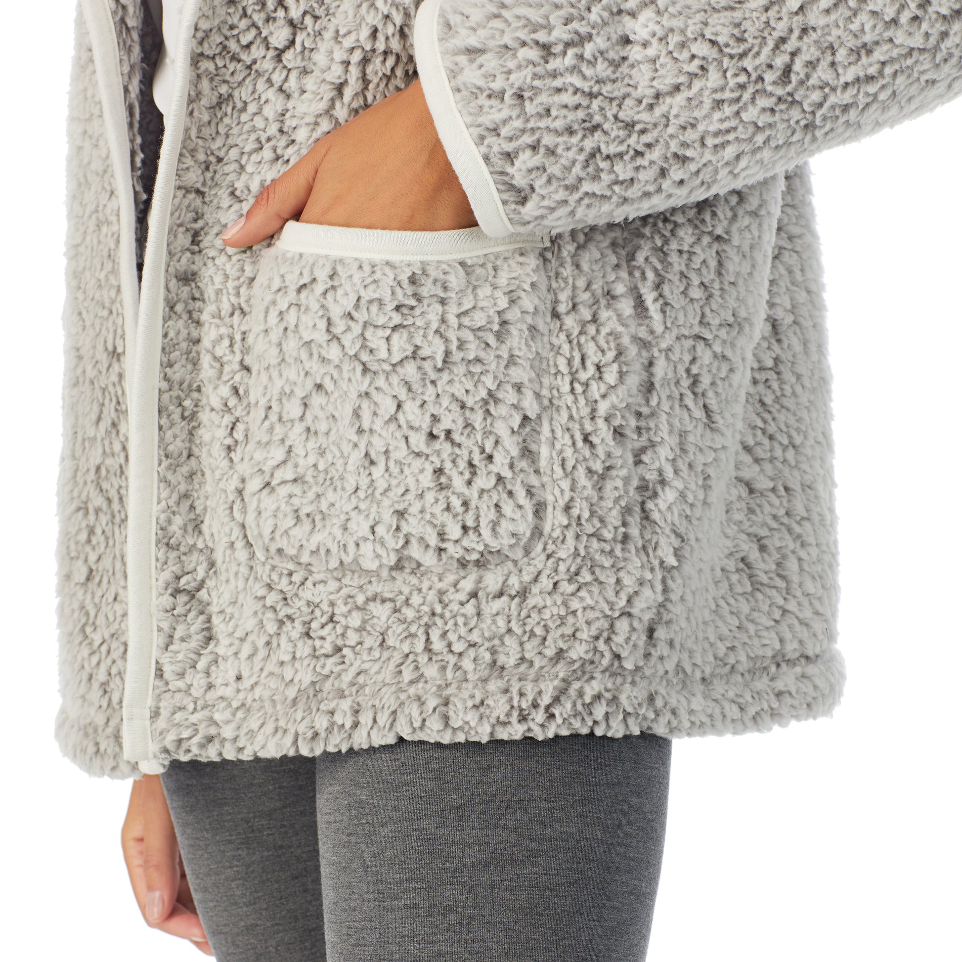 A lady wearing grey sherpa cardi